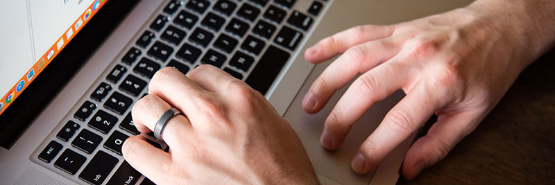 Hands on a laptop keyboard