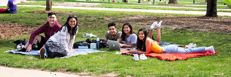 Group of ISU Students sitting outside in the quad on a nice day